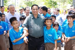 Thủ tướng Phạm Minh Chính với học sinh Trường Hy Vọng. (Ảnh: Dương Giang/TTXVN)