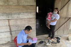 Trung tâm Kiểm soát Bệnh tật tỉnh Đắk Lắk kiểm tra thông tin tiêm chủng phòng bệnh viêm não Nhật Bản tại khu vực ghi nhận trường hợp mắc bệnh tại xã Cư Prao, huyện M'Đrắk (Đắk Lắk). (Ảnh: TTXVN phát)