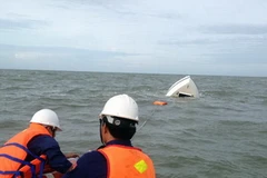 Lực lượng cứu hộ tại nơi chiếc tàu bị chìm ở vùng biển Cần Giờ. (Ảnh: TTXVN)