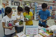 Các em học sinh mua sách vở bình ổn giá và khuyến mại năm học mới 2013-2014 tại Co.op mart Nguyễn Đình Chiểu (TP.Hồ Chí Minh). (Ảnh: Thanh Vũ/TTXVN)