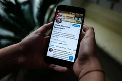 Người dân theo dõi dòng trạng thái trên tài khoản Twitter của Chủ tịch Cuba Miguel Diaz-Canel tại thủ đô La Habana ngày 10/10/2018. (Ảnh: AFP/TTXVN)