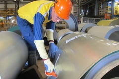 Công nhân Công ty TNHH NS BlueScope đóng gói thành phẩm thép mạ. (Ảnh: Hồng Nhung/TTXVN)