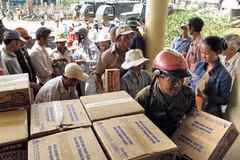 Hỗ trợ lương thực, thực phẩm cho nhân dân vùng bị thiệt hại do bão số 9. (Ảnh: Thanh Long/TTXVN)