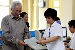 Bác sỹ chỉ dẫn cho bệnh nhân các thủ tục về khám chữa bệnh. (Ảnh: TTXVN)