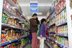 Người tiêu dùng mua sắm tại Co.o mart Đinh Tiên Hoàng, Tp. Hồ Chí Minh. (Ảnh: Thanh Vũ/TTXVN)