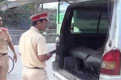 Lực lượng chức năng Đồng Nai điều tra, xác minh xe tôtô làm rơi 2 học sinh xuống quốc lộ 1A tại huyện Trảng Bom. (Ảnh: Sỹ Tuyên/TTXVN)