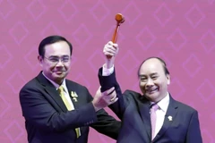 Thủ tướng Nguyễn Xuân Phúc nhận búa Chủ tịch ASEAN từ Thủ tướng Thái Lan Prayuth Chan-o-cha. (Ảnh: Thống Nhất/TTXVN)