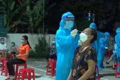 Nhân viên y tế Nghệ An xuyên đêm lấy mẫu xét nghiệm đối với những trường hợp liên quan đến các ca bệnh. (Ảnh: Văn Tý/TTXVN)