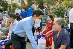 Ông Nguyễn Mạnh Cường, Bí thư quận ủy Thủ Đức, thăm hỏi, trao quà hỗ trợ người dân gặp khó khăn do dịch bệnh. (Ảnh: TTXVN phát)