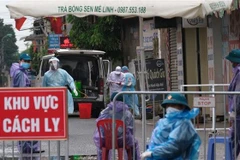 Lực lượng chức năng lập hàng rào cách ly thôn Hạ Lôi (Mê Linh). (Ảnh: Phạm Hùng/TTXVN phát)