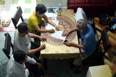 Các cán bộ tổ dân phố Phường Thanh Khê Tây, quận Thanh Khê, Đà Nẵng, ghi chép thông tin tại một trong những hộ có hoàn cảnh khó khăn. (Ảnh: Quốc Dũng/TTXVN)