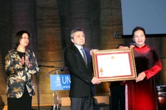 Chủ tịch Quốc hội Nguyễn Thị Kim Ngân trao Huân chương Độc lập hạng Nhất lần thứ hai cho Hội người Việt Nam tại Pháp. (Ảnh: Trọng Đức/TTXVN) 