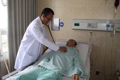 Bác sỹ Quản Minh Trị, Phó khoa ngoại lồng ngực, Bệnh viện Đa khoa Đồng Nai thăm khám cho bệnh nhân Nguyễn Ngọc Tài sau khi phẫu thuật cắt bỏ khối phổi biệt lập và thùy dưới phổi trái. (Ảnh: Lê Xuân/TTXVN)