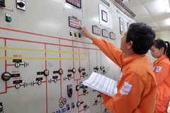 Công nhân đang kiểm tra thông số vận hành máy biến áp. (Ảnh: Mạnh Khánh/TTXVN)