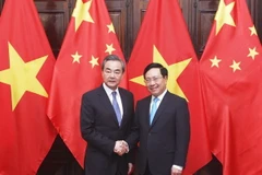 Phó Thủ tướng, Bộ trưởng Bộ Ngoại giao Phạm Bình Minh và Ủy viên Quốc vụ, Bộ trưởng Bộ Ngoại giao Trung Quốc Vương Nghị. (Ảnh: Lâm Khánh/TTXVN) 