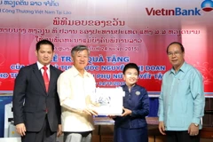 Đại sứ Việt Nam tại Lào Nguyễn Mạnh Hùng đã trao quà tặng của Phó Chủ tịch nước Nguyễn Thị Doan dành tặng Trung tâm Phát triển phụ nữ khuyết tật Lào. (Ảnh: Phạm Kiên/Vietnam+)