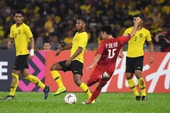 Pha ghi bàn của cầu thủ Việt Nam Phạm Đức Huy vào lưới Malaysia trong trận lượt đi chung kết AFF Suzuki Cup 2018, Kuala Lumpur, Malaysia ngày 11/12/2018. (Nguồn: AFP/TTXVN) 