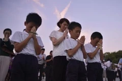 Trẻ em Nhật Bản cầu nguyện cho các nạn nhân bom nguyên tử tại Công viên Hòa bình ở Hiroshima. (Nguồn: Kyodo/TTXVN)