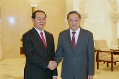 Chủ tịch nước Trần Đại Quang gặp Ủy viên Thường vụ Bộ Chính trị, Chủ tịch Ủy ban toàn quốc Hội nghị Hiệp thương Chính trị nhân dân Toàn quốc Trung Quốc Du Chính Thanh. (Ảnh: Nhan Sáng/TTXVN)