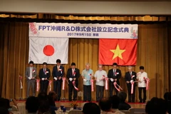 Chủ tịch FPT Trương Gia Bình cũng các đại biểu cắt băng khai trương Trung tâm nghiên cứu - phát triển của FPT (FPTOkinawa R&D) tại Okinawa, Nhật Bản. (Ảnh: Thành Hữu/Vietnam+)