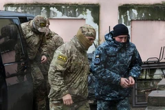 Nhân viên mật vụ thuộc Cơ quan An ninh Liên bang Nga áp giải một thủy thủ Ukraine (phải) bị bắt tới tòa án ở Simferopol, Bán đảo Crimea ngày 27/11/2018. (Nguồn: AFP/ TTXVN)