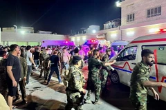 Binh sỹ và lực lượng phản ứng nhanh Iraq chuyển các nạn nhân vụ hỏa hoạn trong đám cưới tới bệnh viện Hamdaniyah ở Al-Hamdaniyah, Iraq ngày 27/9. (Ảnh: AFP/TTXVN)