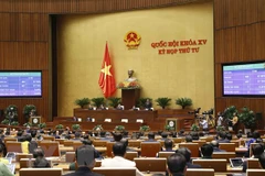 Quốc hội biểu quyết thông qua Nghị quyết đẩy mạnh việc thực hiện chính sách, pháp luật về thực hành tiết kiệm, chống lãng phí. (Ảnh: Doãn Tấn/TTXVN)