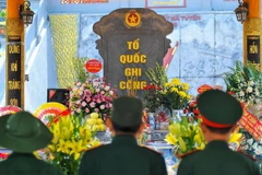 Các cựu chiến binh thắp hương tưởng nhớ các liệt sỹ tại Nghĩa trang liệt sỹ quốc gia Vị Xuyên, tỉnh Hà GIang. (Ảnh: Nam Thái/TTXVN)