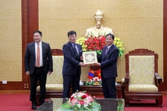 Chủ tịch UBND tỉnh Hòa Bình Bùi Văn Khánh tặng quà lưu niệm cho Đoàn công tác. (Ảnh: Vũ Hà/TTXVN)