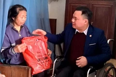 Lương y Trần Quang Dũng tặng quà cho gia đình khó khăn. (Ảnh: Lưu Thanh Tuấn/TTXVN)