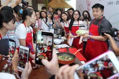 Đầu bếp Hàn Quốc Lee Won-il hướng dẫn các học viên làm món Thịt hầm cải thảo. (Ảnh: Lâm Khánh/TTXVN)