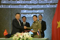 Bộ trưởng Công an Tô Lâm và Tư lệnh Cảnh sát Hoàng gia Thái Lan trao đổi văn kiện hợp tác. (Ảnh: Sơn Nam/TTXVN)