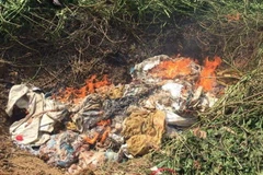 Lực lượng chức năng tiến hành tiêu hủy số thực phẩm bẩn bị bắt giữ. (Ảnh: Quang Cường/TTXVN)