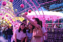 Du khách chụp ảnh tại một trung tâm mua sắm ở thủ đô Bangkok. (Nguồn: THX/TTXVN)