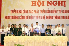 Phó Thủ tướng Vũ Đức Đam và các đại biểu tham dự lễ khai trương cổng dữ liệu y tế và hệ thống thông tin giám định Bảo hiểm Y tế. (Ảnh: Dương Ngọc/TTXVN)