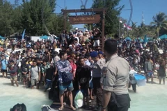 Hàng trăm khách du lịch chờ sơ tán khỏi Gili Trawangan, khu vực lân cận đảo Lombok, Indonesia. (Nguồn: AFP/TTXVN)