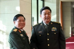 Hai Bộ trưởng Bộ Quốc phòng bắt tay thân mật. (Ảnh: Vĩnh Hà/Vietnam+)