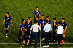 Huấn luyện viên U22 Campuchia (chống nạng) chỉ đạo các cầu thủ. (Ảnh: TTXVN) 