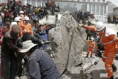 Các nhân viên cứu hộ nỗ lực tìm cứu các nạn nhân bị chôn vùi trong đống đổ nát. (Ảnh: THX/TTXVN) 