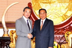 Chủ tịch Chummaly Saynhasone tiếp Bộ trưởng Ngoại giao Trung Quốc Vương Nghị. (Ảnh: Hoàng Chương/Vietnam+)