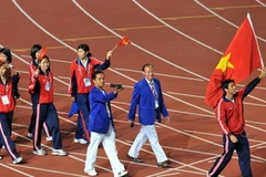 Đoàn Thể thao Việt Nam diễu hành tại lễ bế mạc SEA Games 25. (Ảnh: Quang Nhựt/TTXVN)
