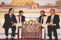 Chủ tịch Chummaly Saynhasone tiếp Ủy viên Bộ Chính trị, Tô Huy Rứa. (Ảnh: Hoàng Chương/Vietnam+)