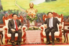 Tổng Bí thư, Chủ tịch nước Lào Thongloun Sisulith tiếp đồng chí Nguyễn Xuân Thắng. (Ảnh: Xuân Tú/TTXVN)