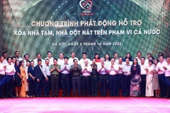 Thủ tướng Phạm Minh Chính với các đại diện các tổ chức, doanh nghiệp hỗ trợ kinh phí xóa nhà tạm, nhà dột nát. (Ảnh: Dương Giang/TTXVN)