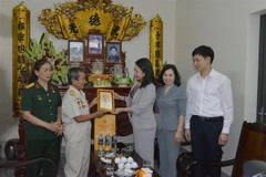 Phó Chủ tịch nước Võ Thị Ánh Xuân tặng quà và bức ảnh Chủ tịch Hồ Chí Minh cho thương binh Phạm Văn Sách xã Việt Dân, thị xã Đông Triều. (Ảnh: Thanh Vân/TTXVN)