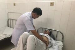 Bác sỹ thăm khám cho bệnh nhân sau khi tán sỏi. (Ảnh: TTXVN phát)