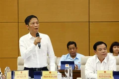 Bộ trưởng Bộ Công Thương Trần Tuấn Anh trả lời các câu hỏi của đại biểu. (Ảnh: Văn Điệp/TTXVN)