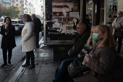 Người dân đợi xe buýt sau khi hoạt động giao thông đường sắt bị đình trệ do bãi công tại Thessaloniki. (Nguồn: AFP/TTXVN)