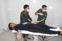 Bác sỹ Quân y điều trị vết thương cho ngư dân gặp nạn. (Ảnh minh họa: TTXVN phát)