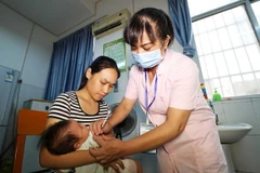 Tiêm vắcxin cho một em nhỏ tại bệnh viện ở Rongan, tỉnh Quảng Tây, Trung Quốc ngày 23/7. (Ảnh: AFP/TTXVN)